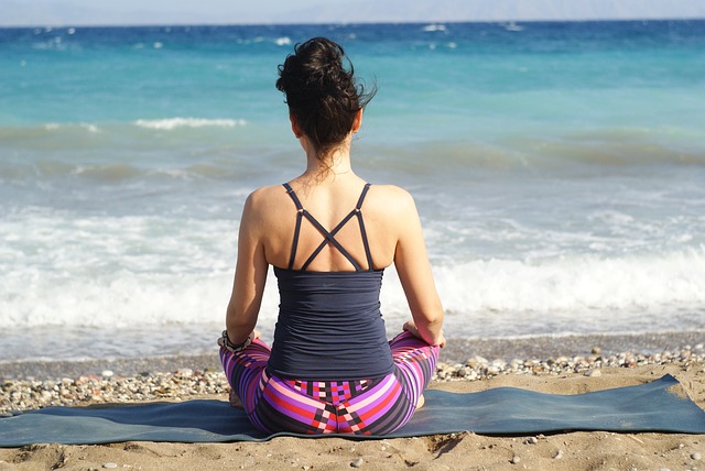 woman yoga beach